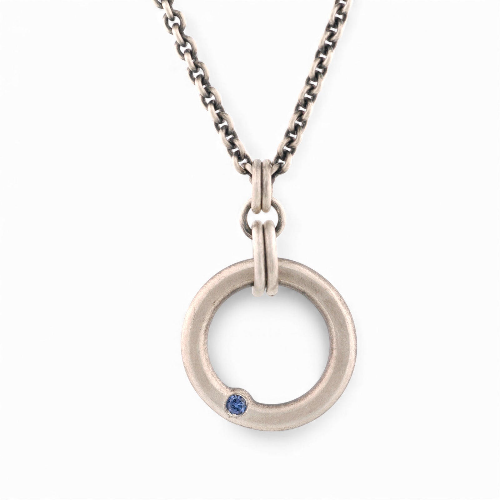 Sterling Silver Circle Pendant with a Sapphire