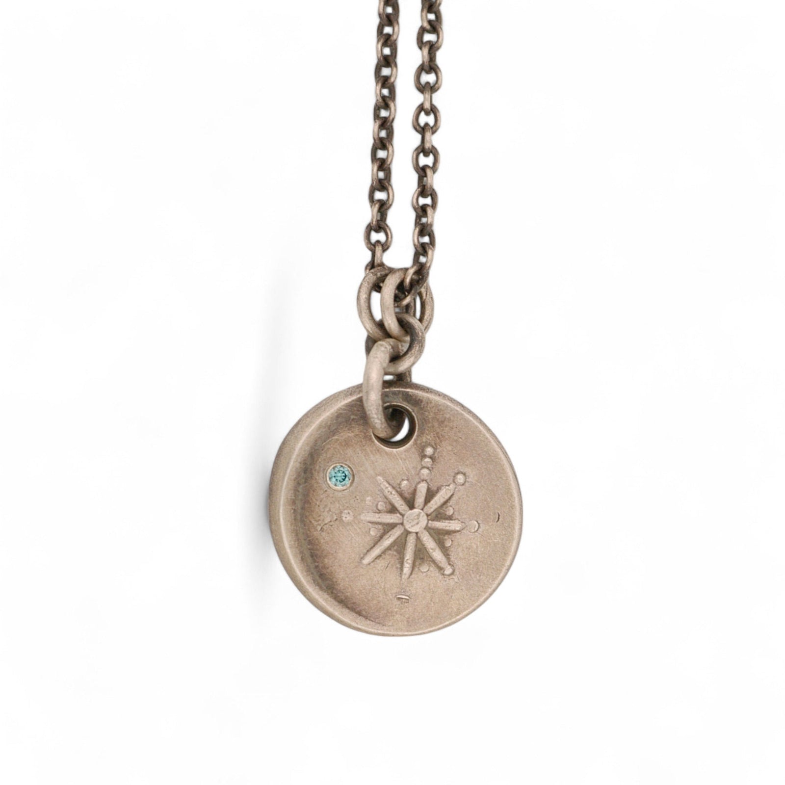 Round Sterling Silver Christmas Star Pendant with a Blue Diamond