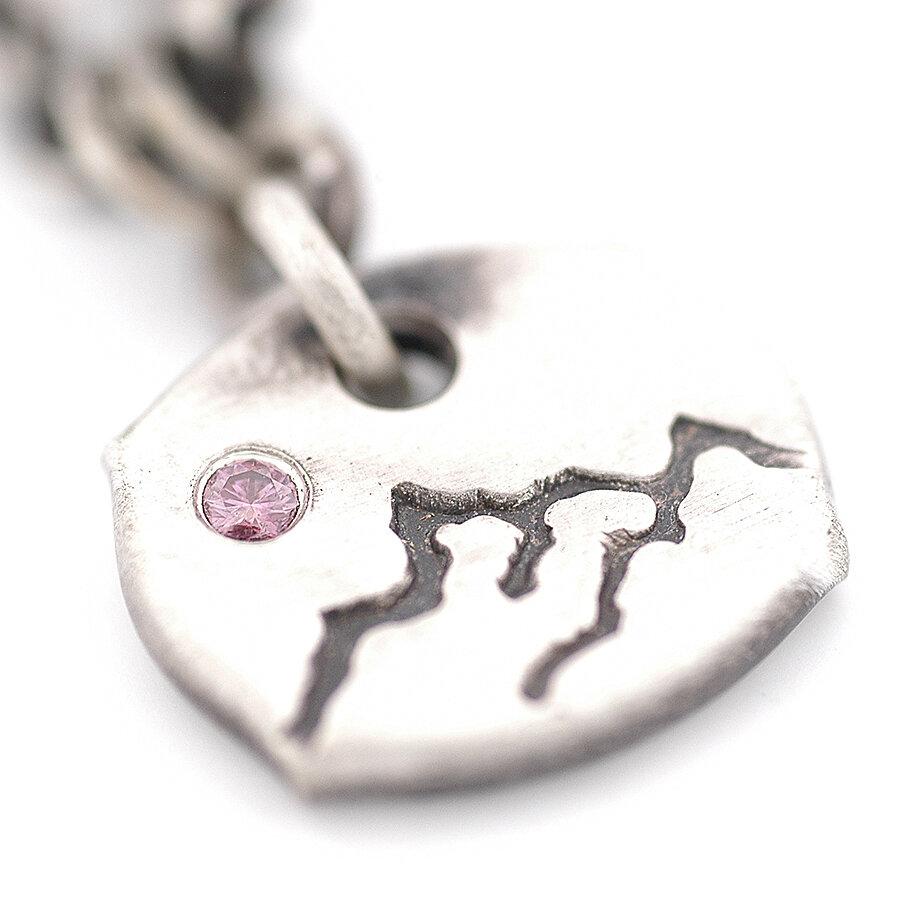 Pink diamond setting over a hand stamped mountain range
